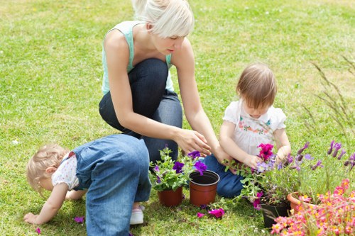 Inspection of garden borders and plants by a gardener checking work quality
